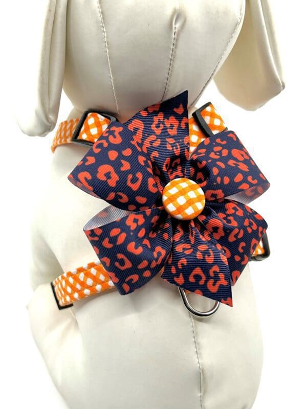 An Orange Check w/ Optional Team Bow Choices- "H" Style Harness dog harness with a polka dot bow.