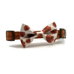 A bow tie with an orange flower on it.