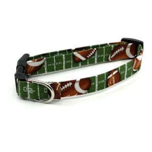 A green dog collar with footballs on it.