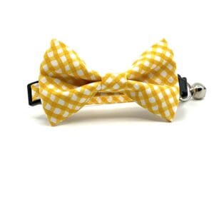 A yellow and white gingham bow tie on a white background.