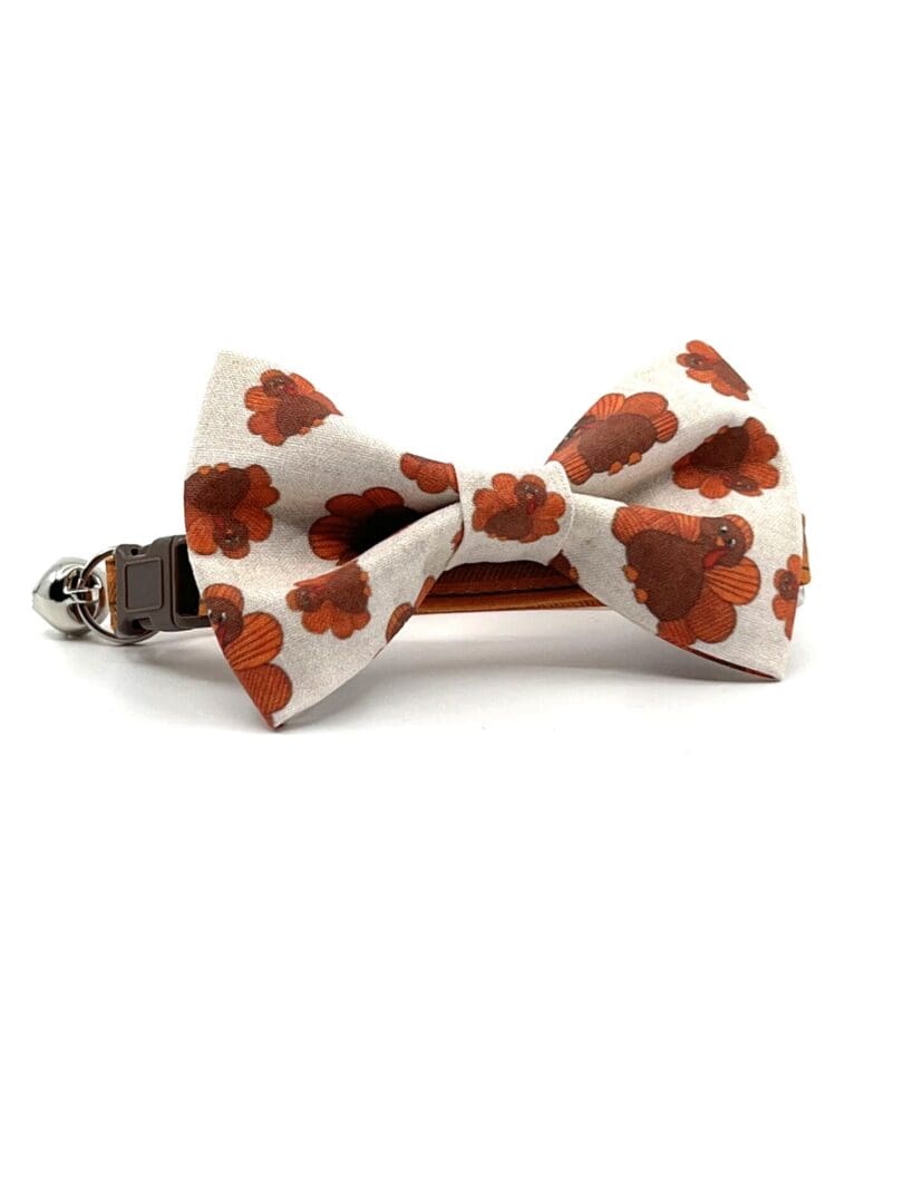 A bow tie with orange flowers on it.