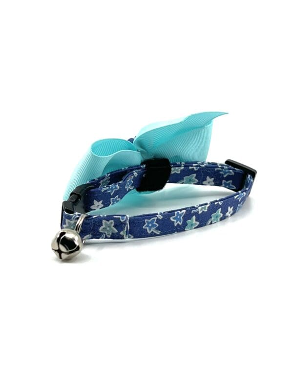 A blue cat collar with a blue bow.