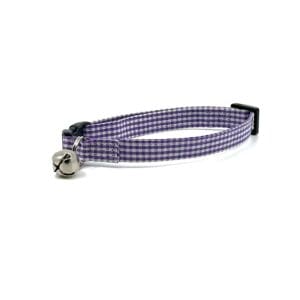 A purple and white plaid cat collar with a bell.