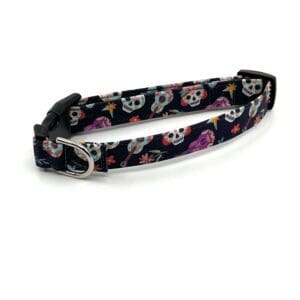 A dog collar with skulls and flowers on it.