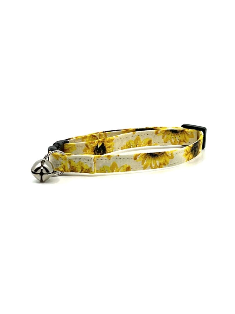 A cat collar with sunflowers on it.