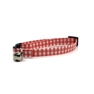 A red and white gingham cat collar with a bell.