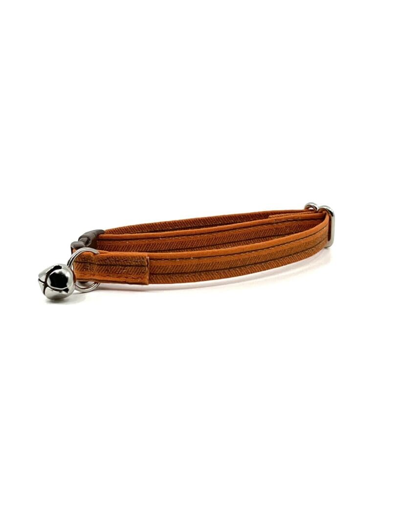 A brown leather collar with a bell.