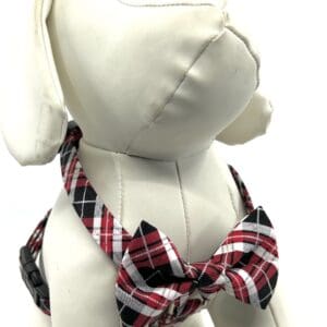 A stuffed dog wearing a red and black plaid collar.