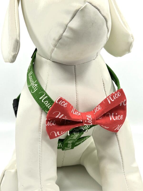 A bow tie that says " nice " and " merry ".