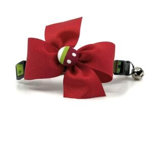 A red bow with green and white accents.
