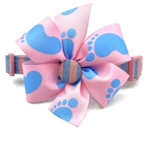 A pink and blue bow with footprints on it.