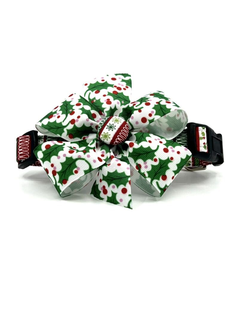 A bow tie that is decorated with christmas holly.