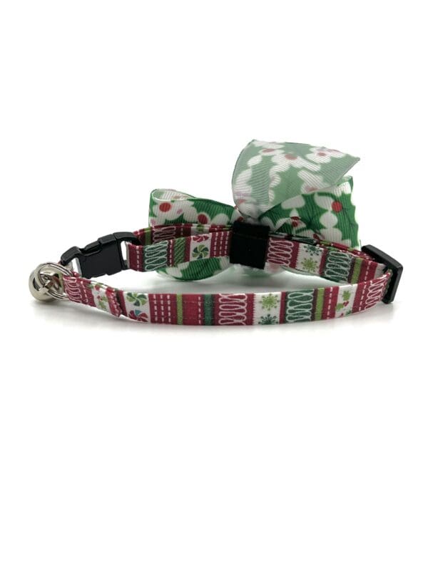 A cat collar with a bow tie and a bell.