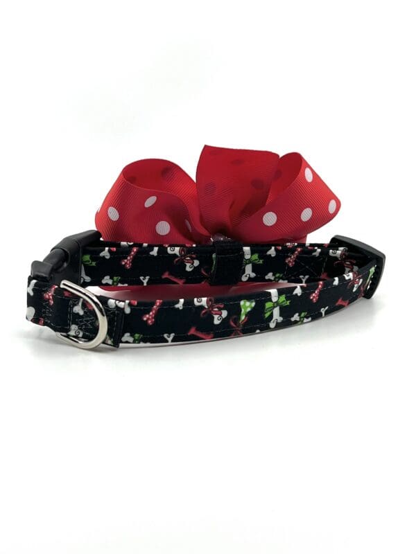 A dog collar with a bow on it.