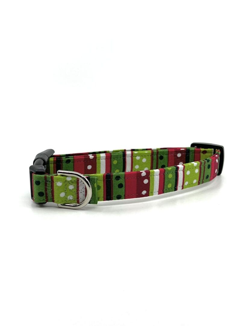 A dog collar with a red, green and white pattern.