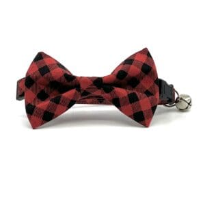 A red and black bow tie with bell attached.