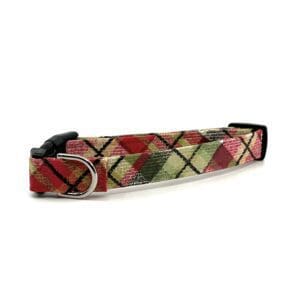 A dog collar that has a red and green argyle pattern.