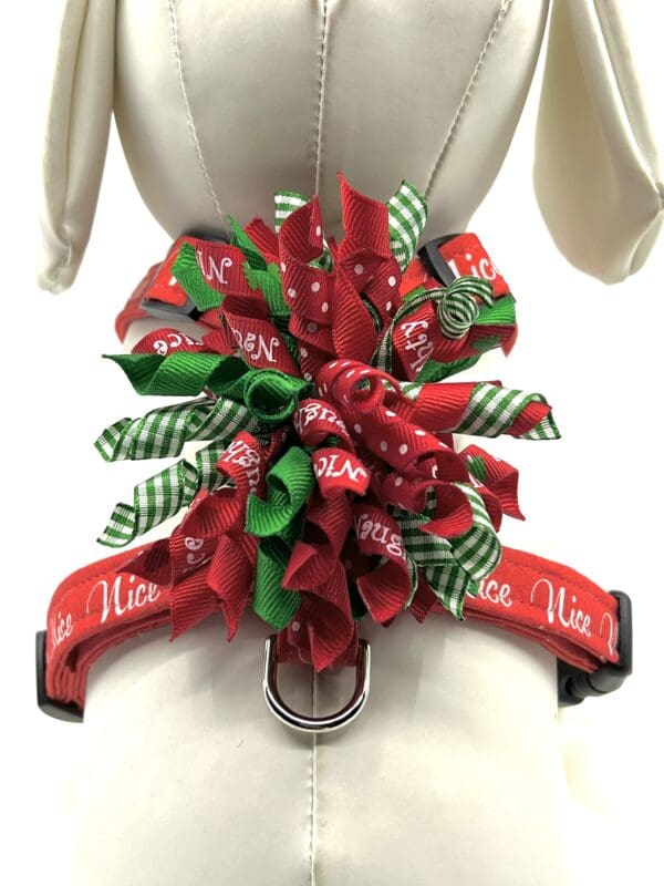 A red and green dog collar with bows on it.