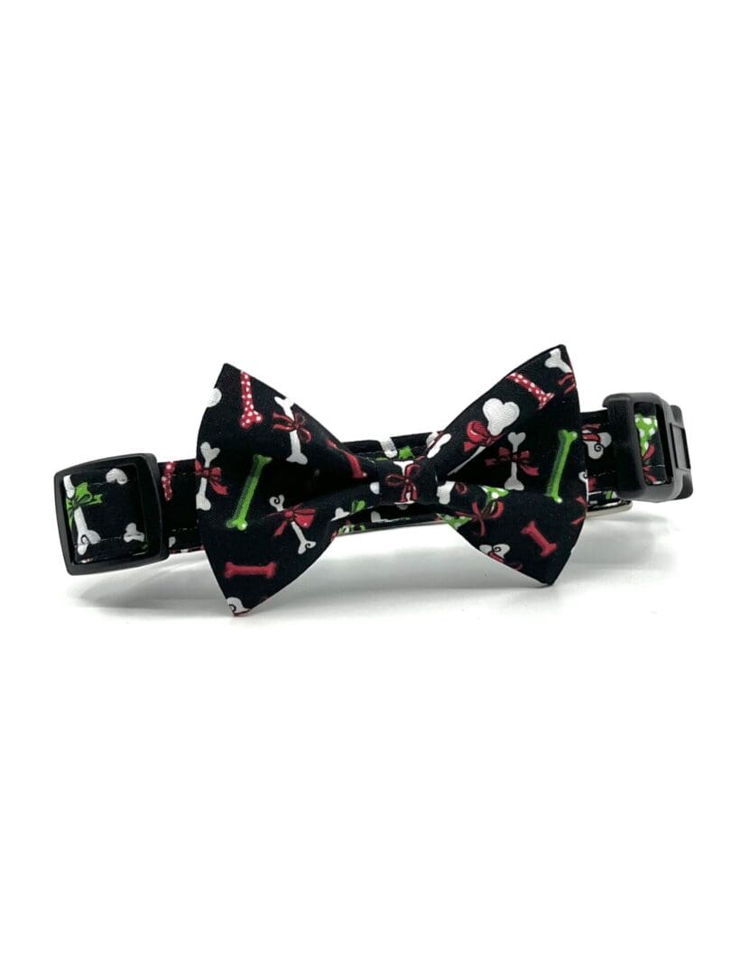 A black dog collar with a bow tie on it.