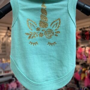 A light blue tank top with a gold design on it.