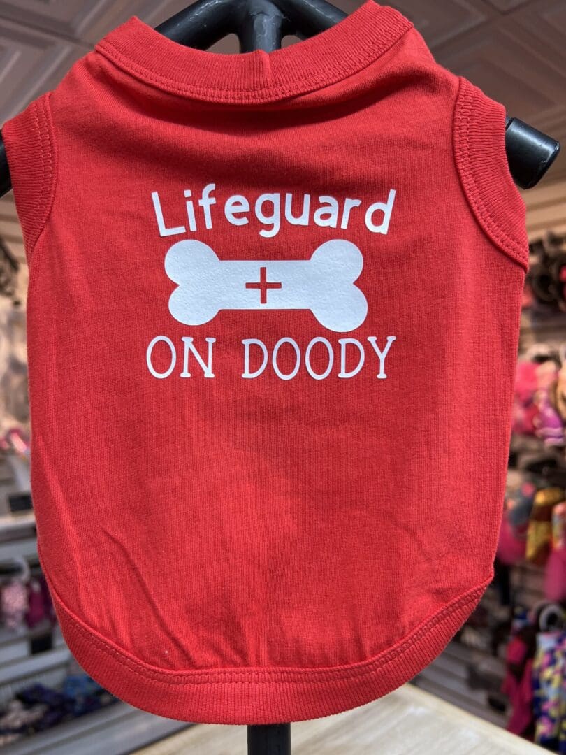 A red shirt that says lifeguard on doody