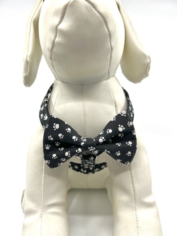 A dog wearing a bow tie with skulls on it.
