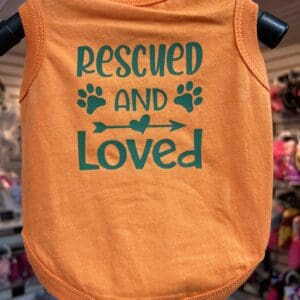 A dog shirt that says " rescued and loved ".
