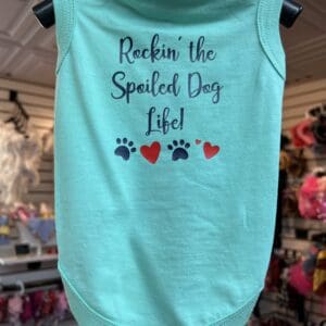 A dog shirt that says " rockin the spoiled dog life ".