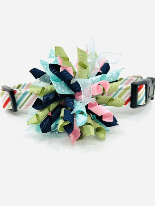 A dog collar with a colorful flower on it.