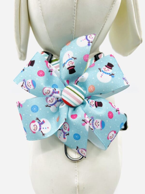 A blue bow with snowmen and hearts on it.