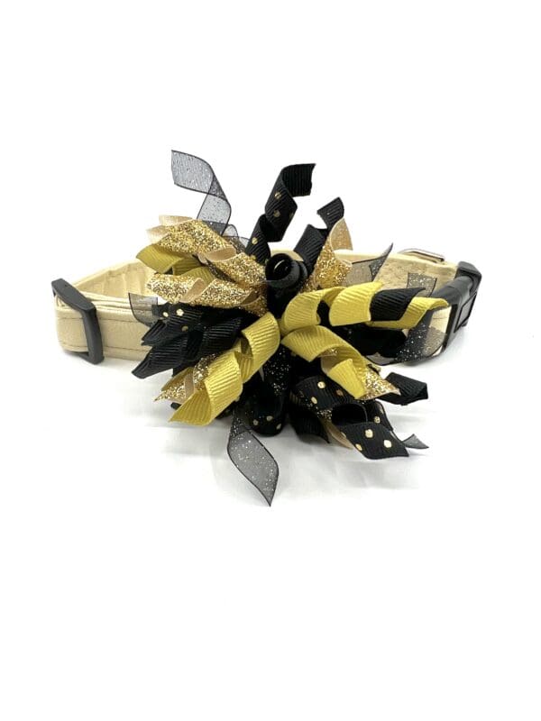 A yellow and black bow on top of a dog collar.