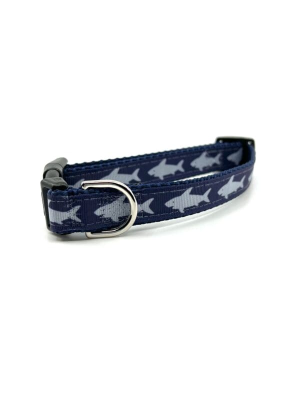 A dog collar with a picture of sharks on it.