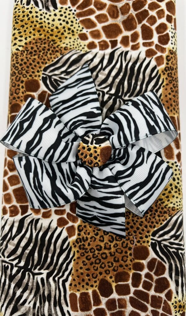 A zebra print and giraffe print blanket with a large flower.