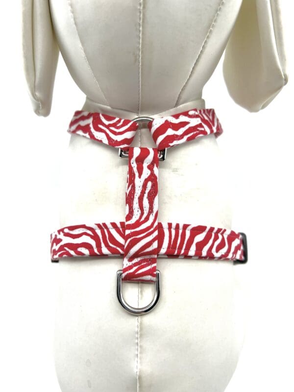 A red and white zebra print harness on the back of a shirt.