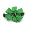 A green flower with purple beads on top of it.