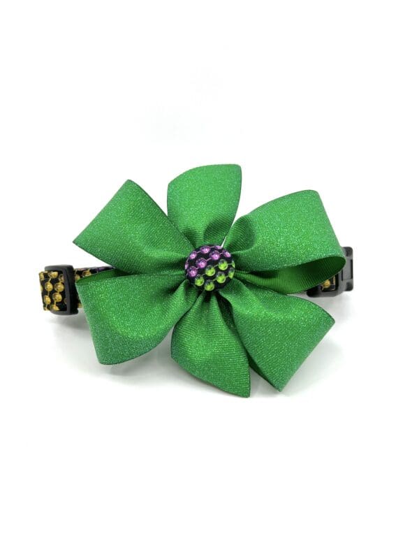 A green flower with purple beads on top of it.