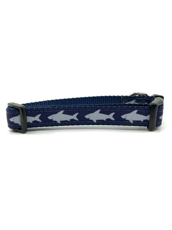 A blue and white shark pattern dog collar.