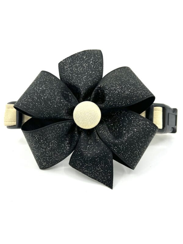 A black flower with gold accents on top of it.