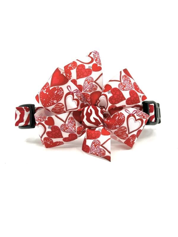 A red and white bow tie with hearts on it.