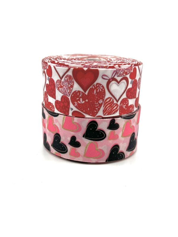 A pair of hearts and polka dots on two rolls of ribbon.