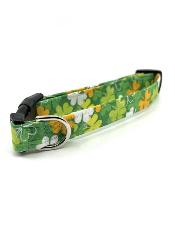 A green and yellow collar with four leaf clovers.