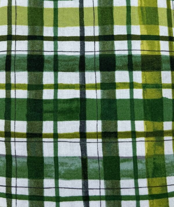 A close up of the green and white plaid fabric.