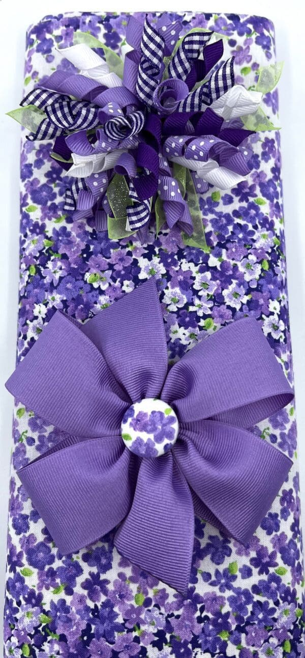 A purple gift wrap with a bow on it.