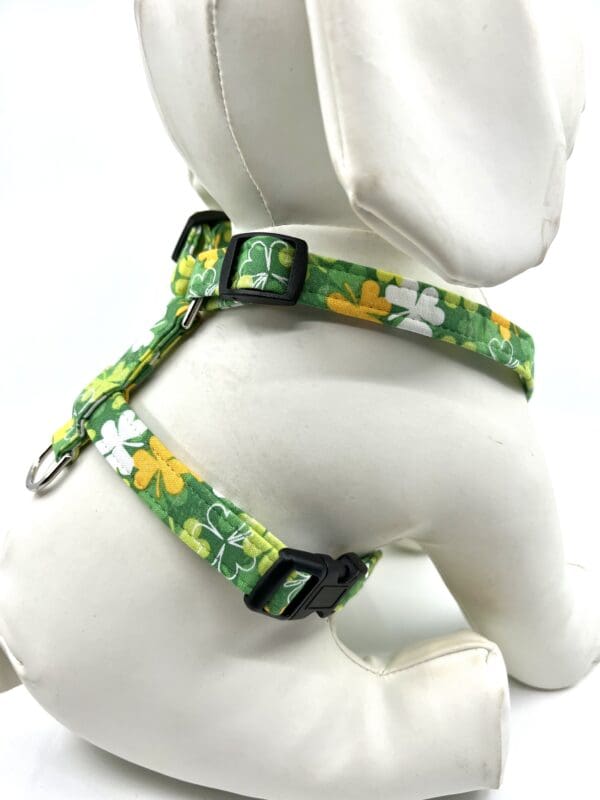 A dog wearing a harness with flowers on it.