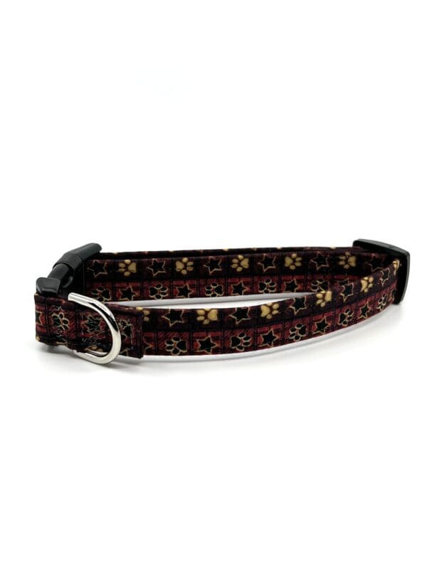 A brown dog collar with gold and black pattern.