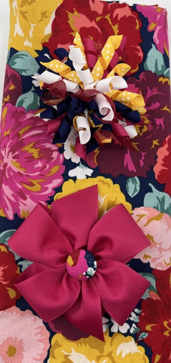 A close up of two bows on top of a floral fabric.