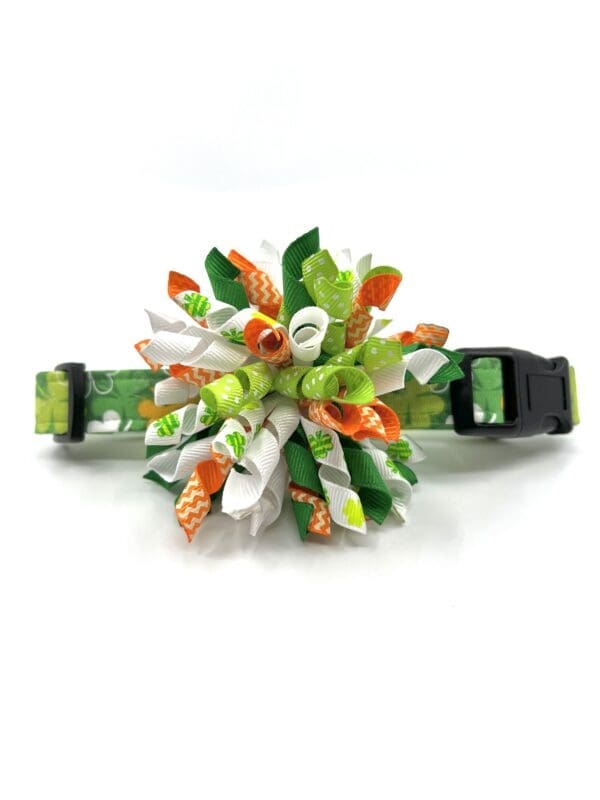 A green, orange and white flower collar for dogs.