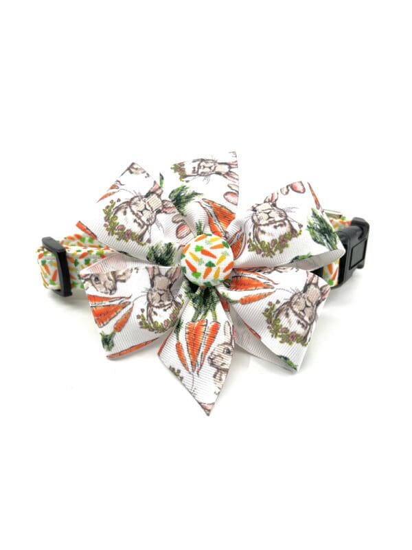 A dog collar with a bow of carrots.
