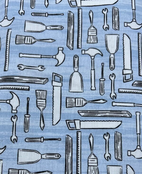 A blue fabric with many different tools on it