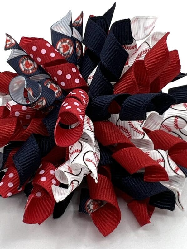 A red, white and blue ribbon wreath with a button.